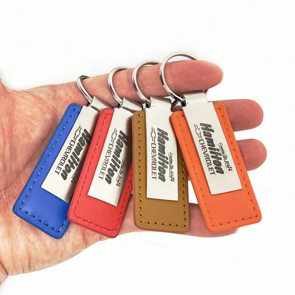 Custom laser-engraved leather keyrings in blue, red, tan and orange